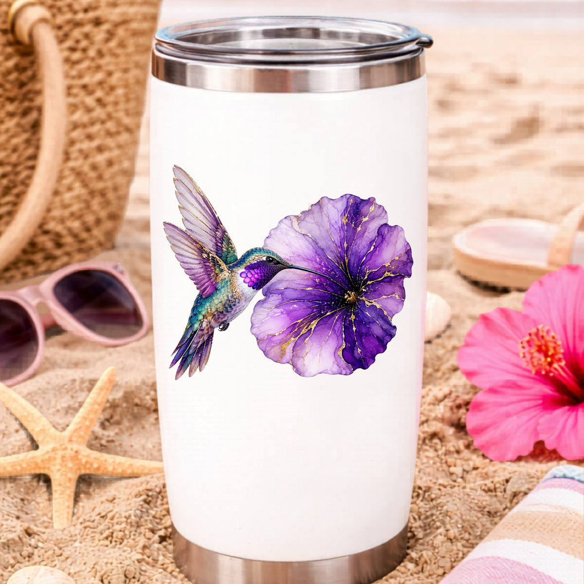 Hummingbird Purple Petunia UV DTF sticker applied to a white travel tumbler on beach sand