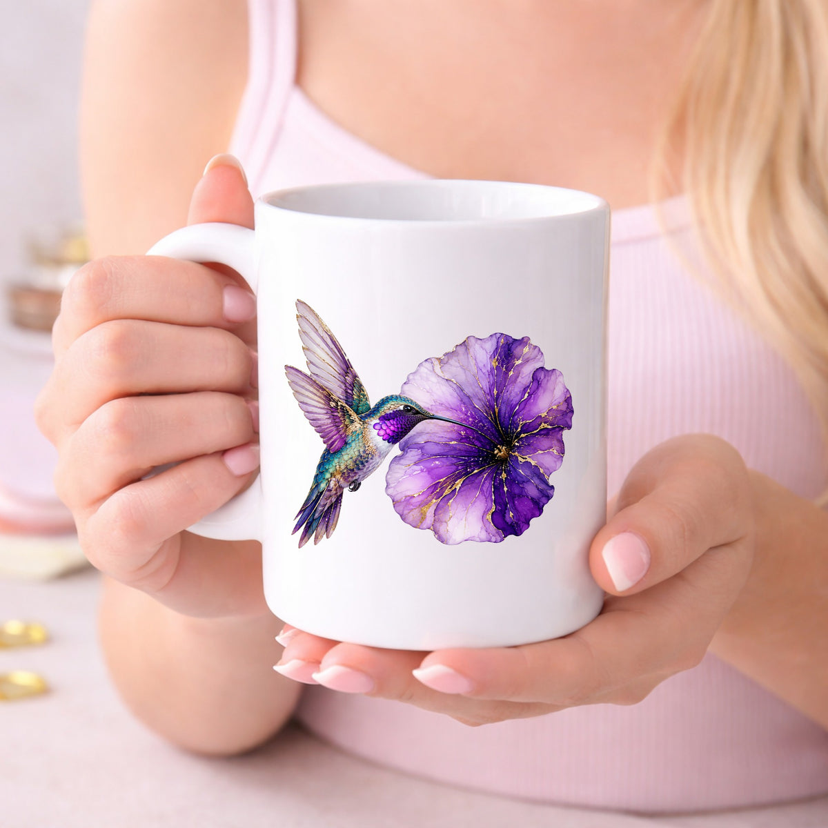 Hummingbird Purple Petunia UV DTF sticker applied to a white coffee mug held in both hands