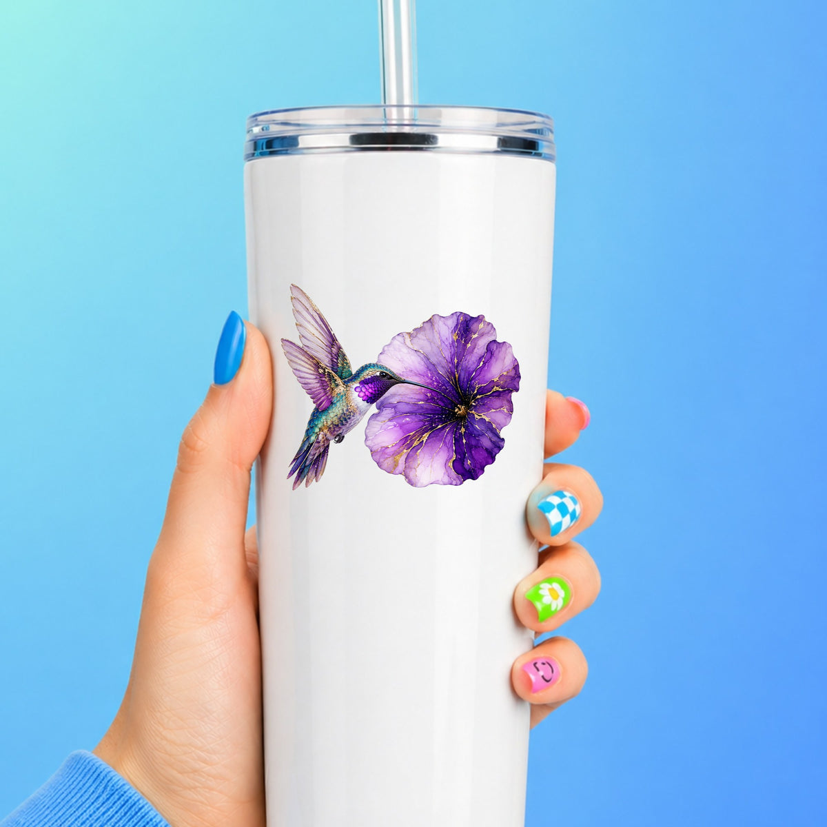 Hummingbird Purple Petunia UV DTF sticker applied to a white straw tumbler on a blue background