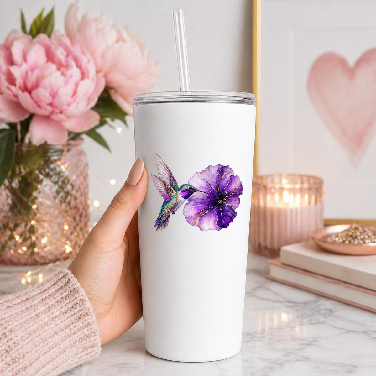 Hummingbird Purple Petunia UV DTF sticker applied to a white straw tumbler beside pink peonies