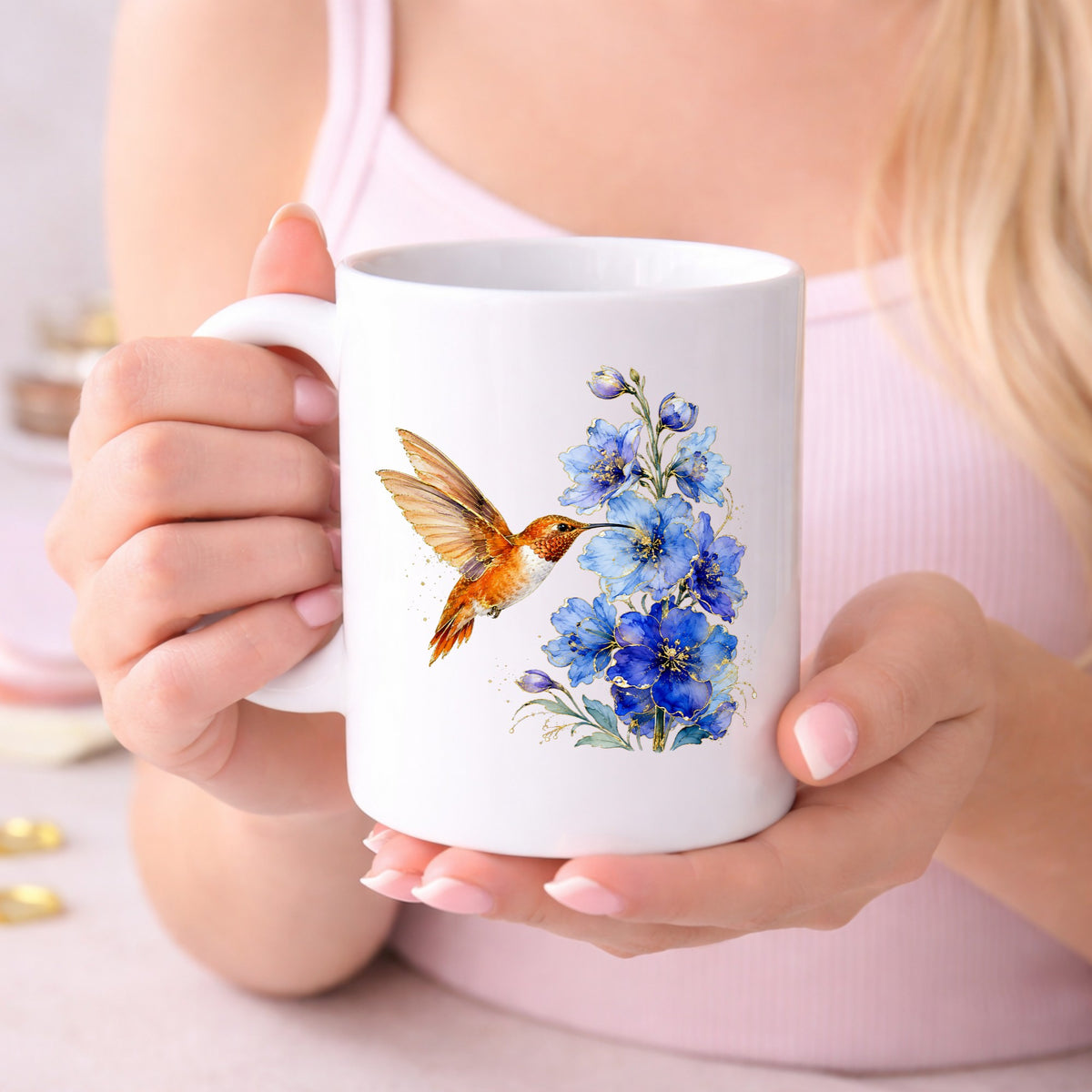 Rufous Hummingbird Blue Delphinium UV DTF sticker applied to a white coffee mug held in both hands