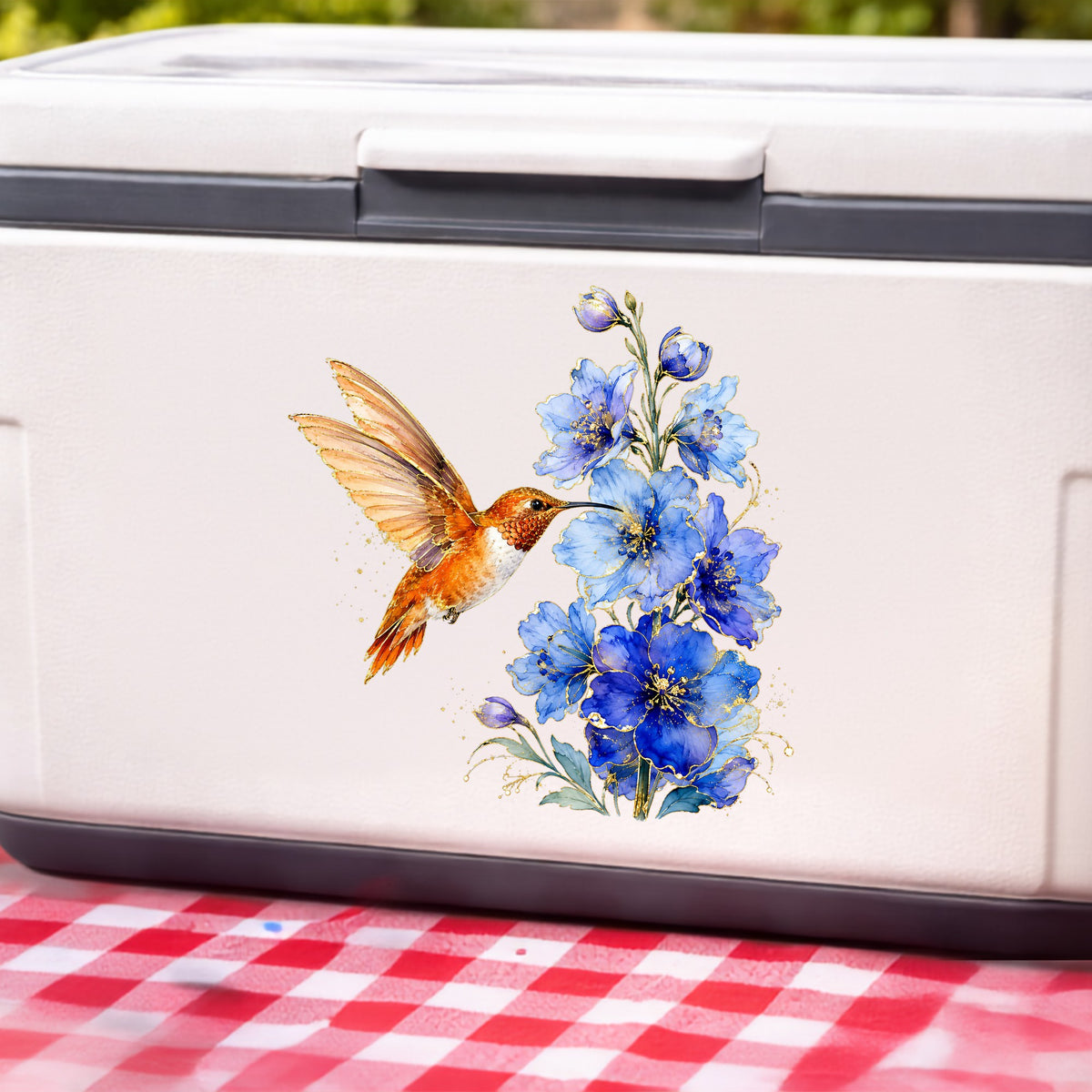 Rufous Hummingbird Blue Delphinium UV DTF sticker applied to a white cooler on a red gingham cloth
