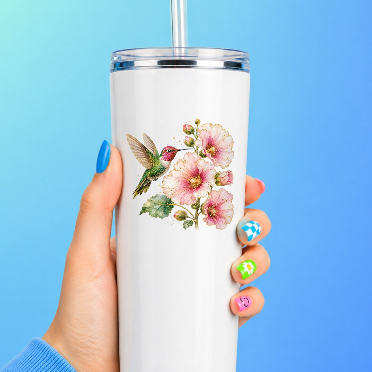 Hummingbird Pink Hollyhock UV DTF sticker applied to a white straw tumbler on a blue background