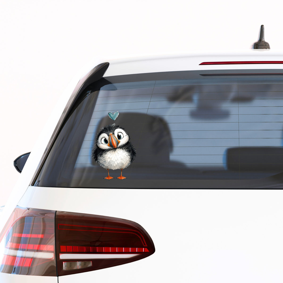 Funny Puffin UV DTF sticker applied to the rear window of a white car