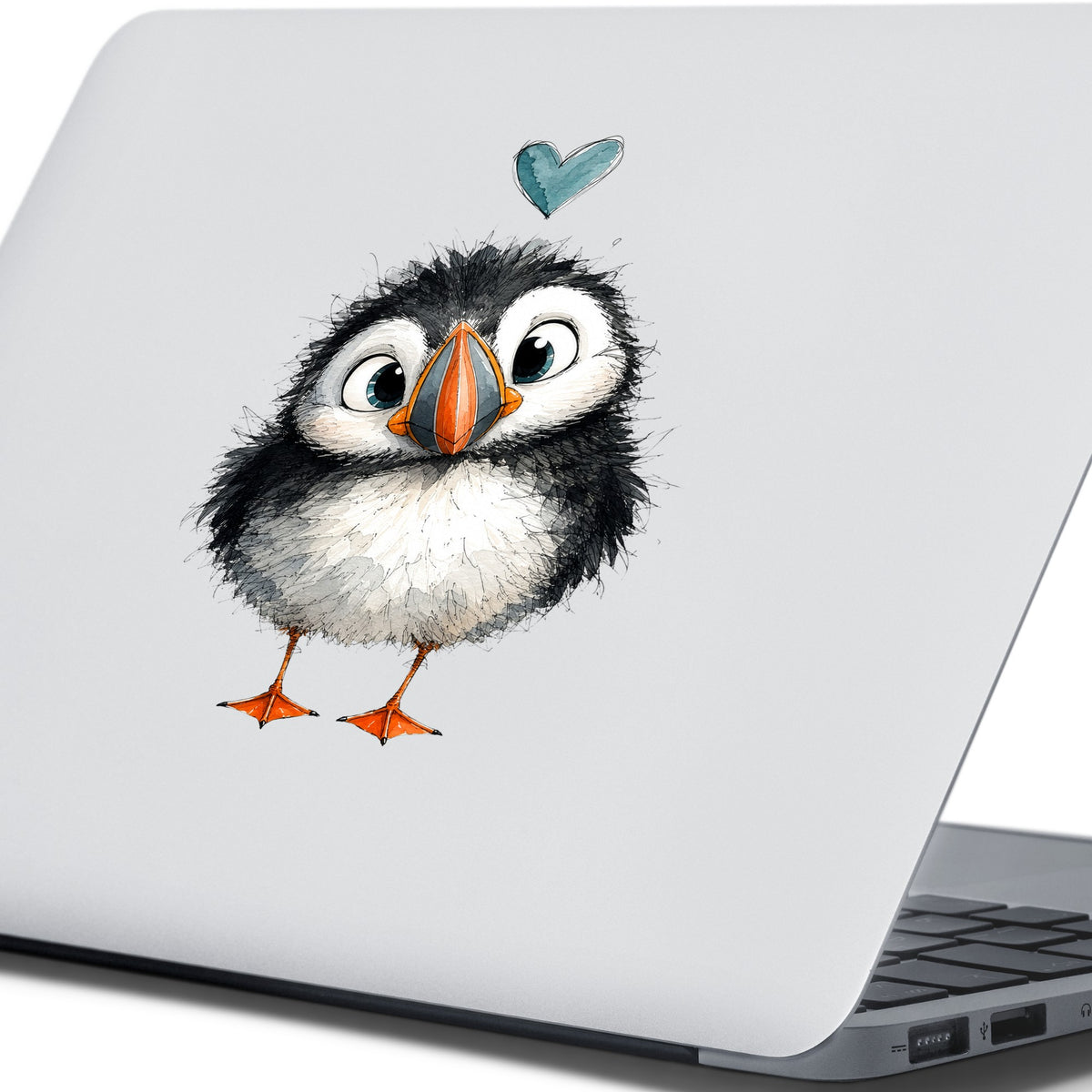 Funny Puffin UV DTF sticker applied to the lid of a silver laptop