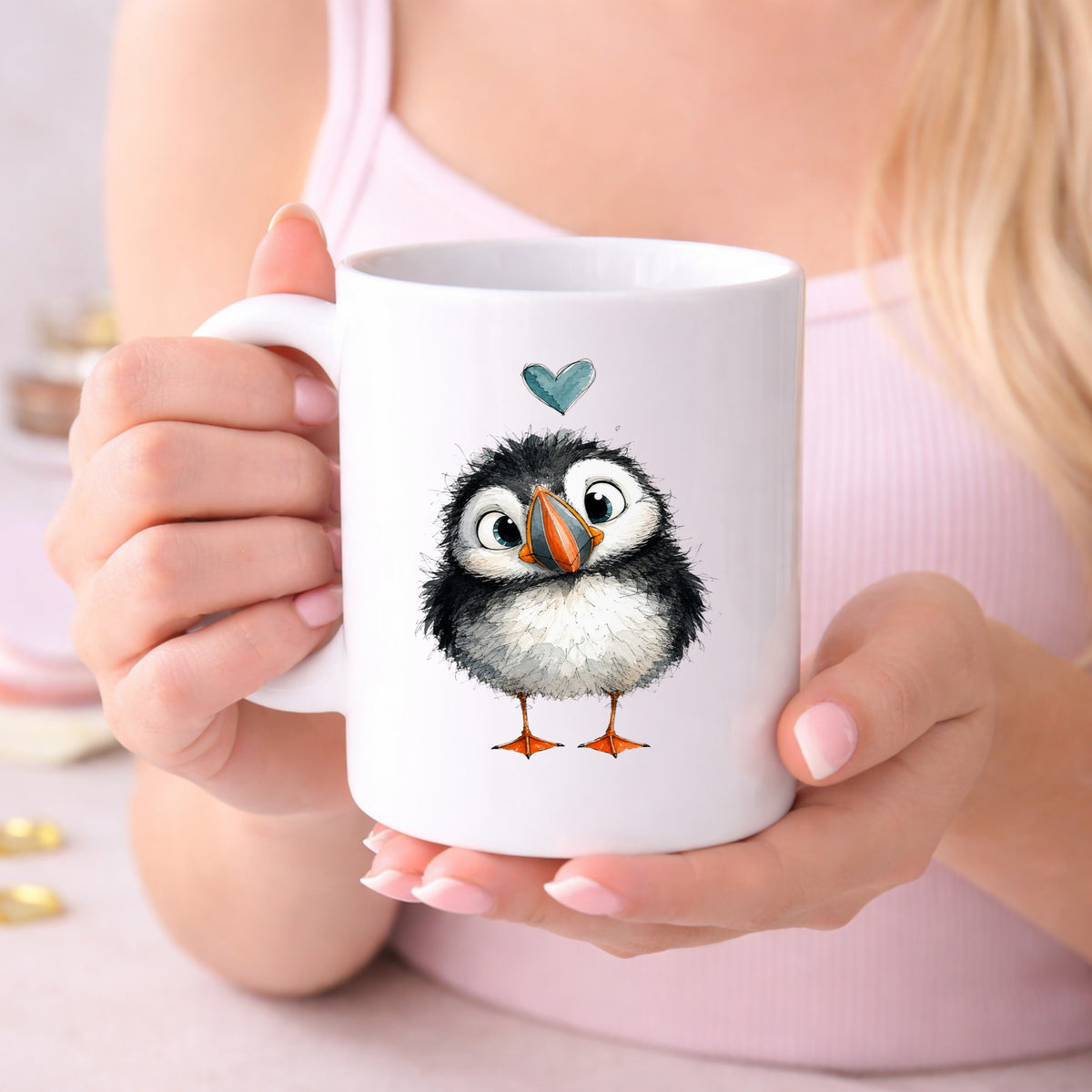 Funny Puffin UV DTF sticker applied to a white coffee mug held in both hands