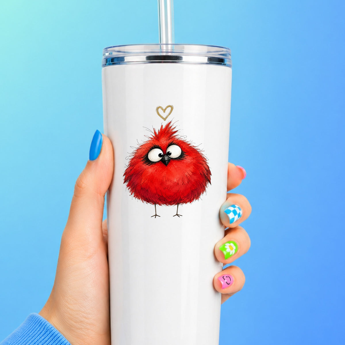 Fluffy Red Cardinal UV DTF sticker applied to a white straw tumbler on a blue background