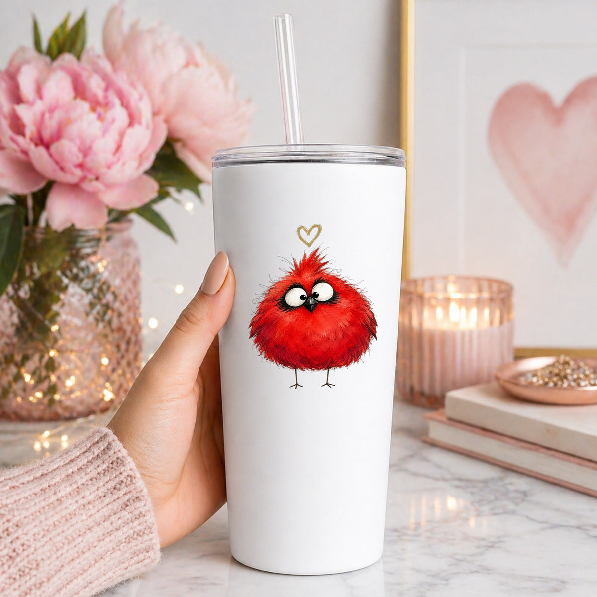 Fluffy Red Cardinal UV DTF sticker applied to a white straw tumbler beside pink peonies
