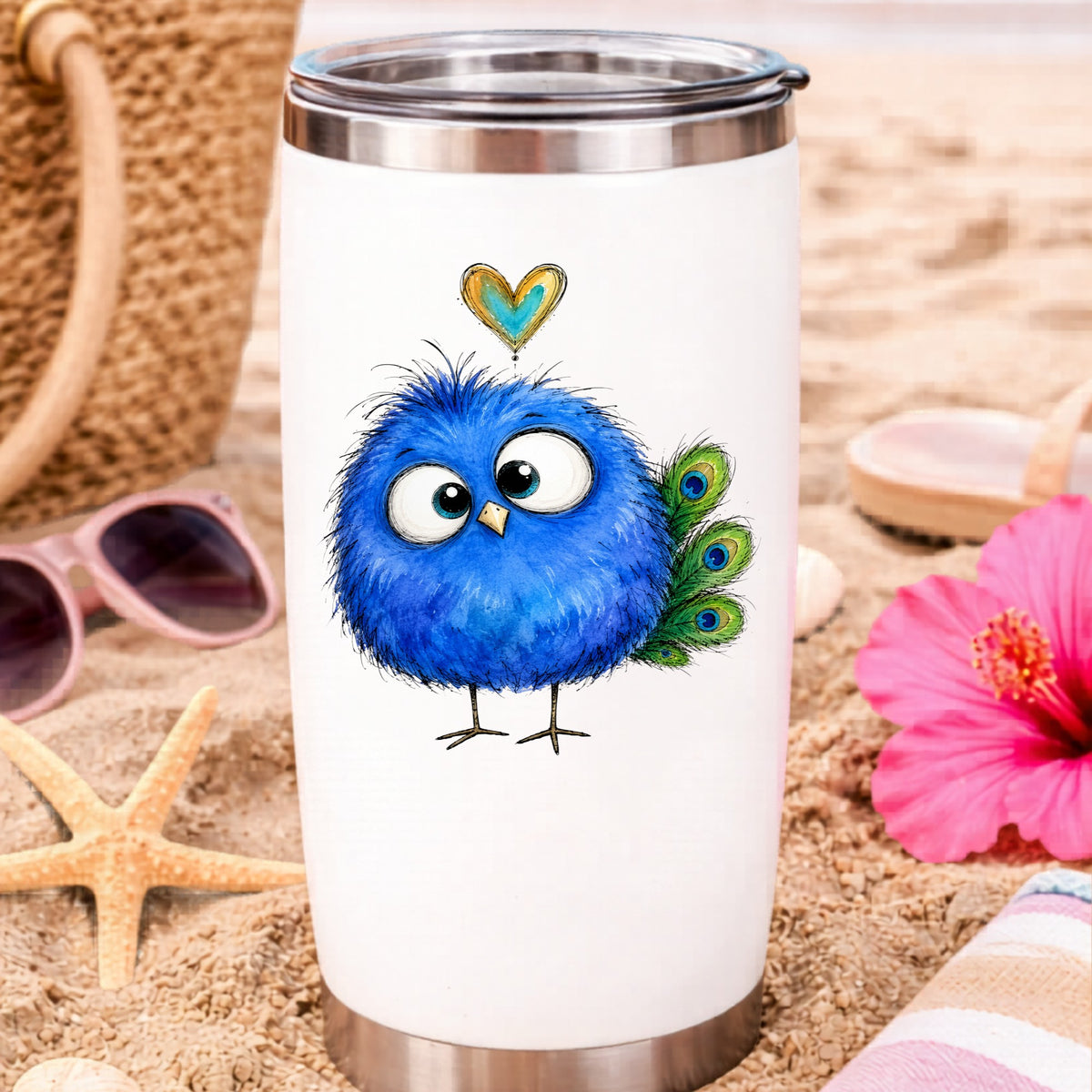 Funny Blue Peacock UV DTF sticker applied to a white travel tumbler on beach sand