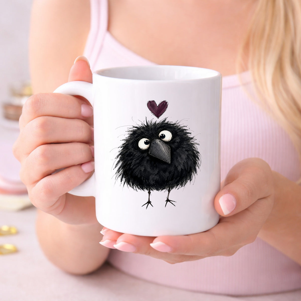 Fluffy Black Crow UV DTF sticker applied to a white coffee mug held in both hands