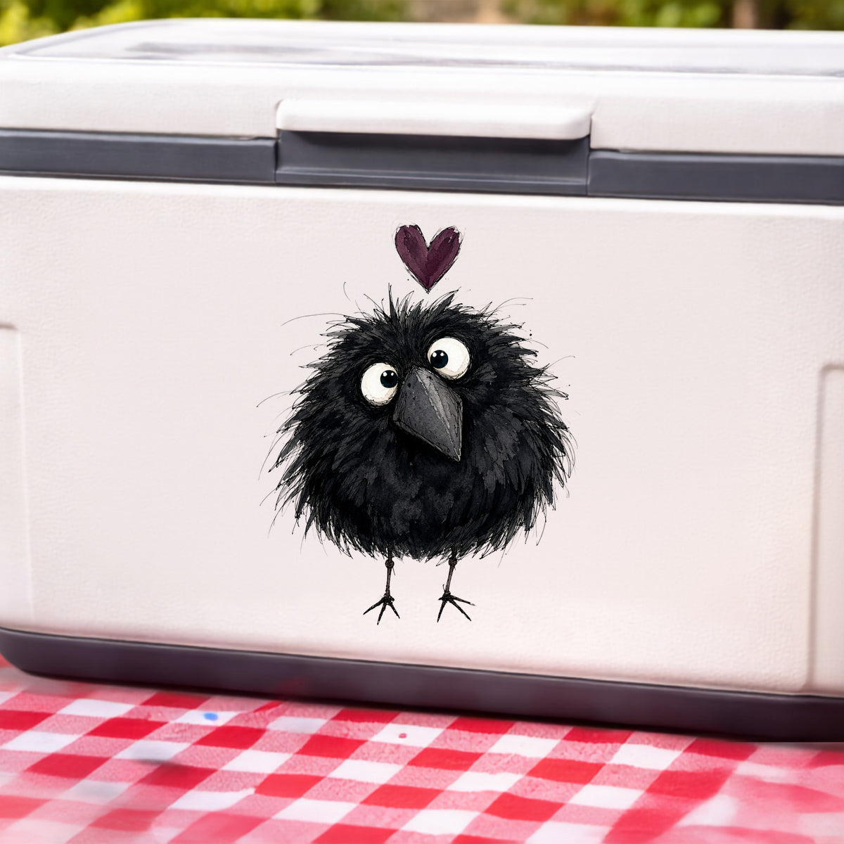 Fluffy Black Crow UV DTF sticker applied to a white cooler on a red gingham cloth
