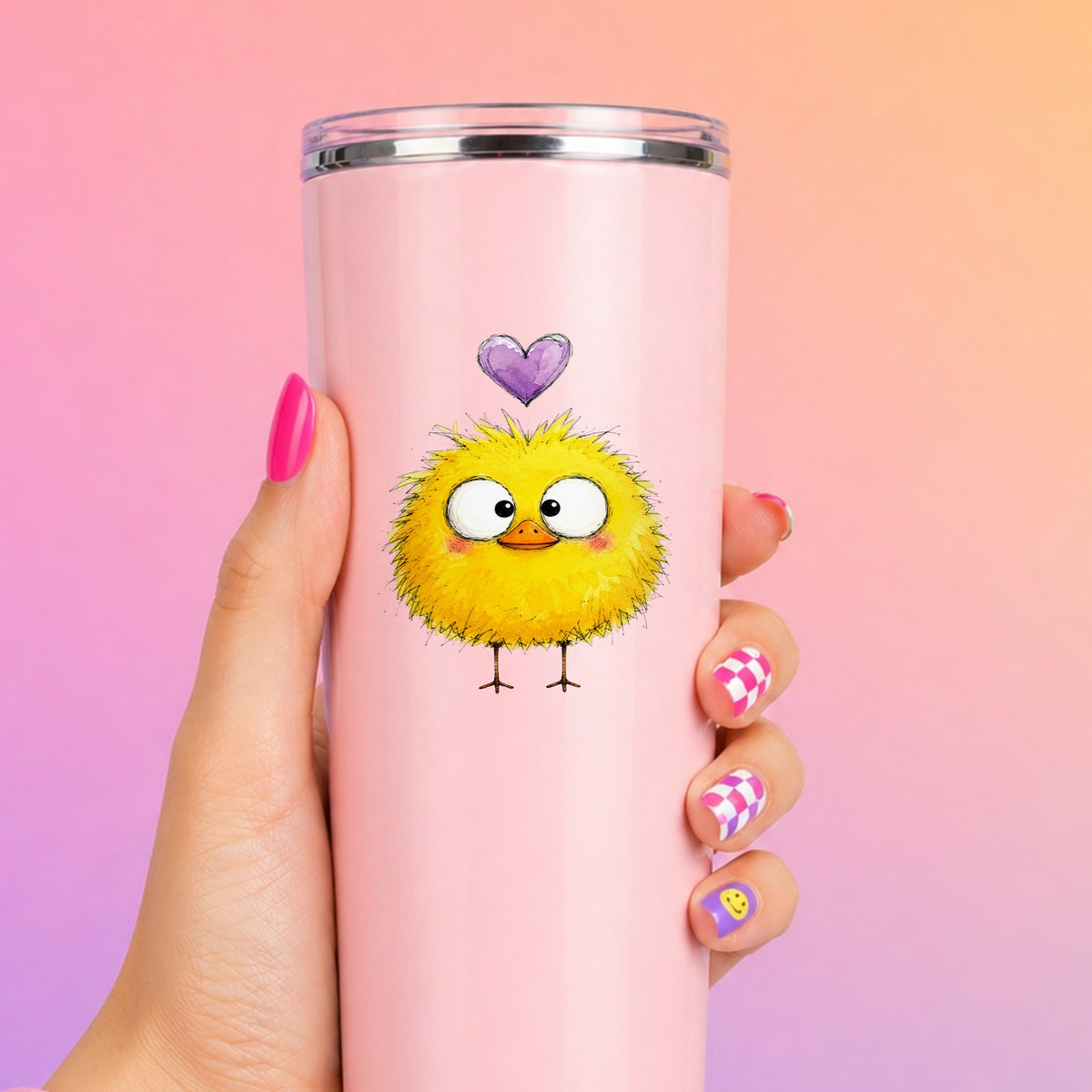 Fluffy Yellow Duckling UV DTF sticker applied to a tall pink tumbler on a pink and orange background