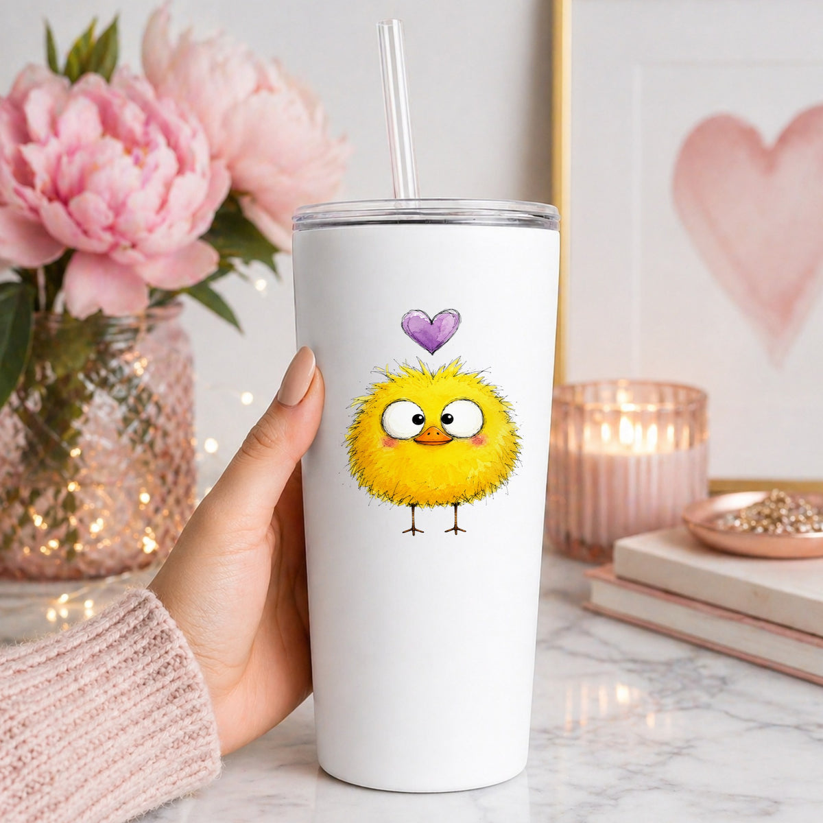 Fluffy Yellow Duckling UV DTF sticker applied to a white straw tumbler beside pink peonies