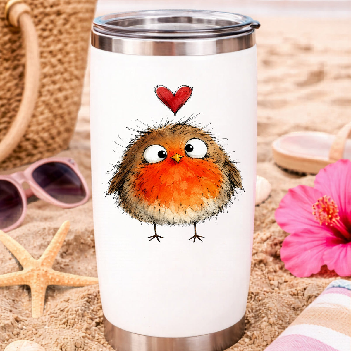 Fluffy Robin UV DTF sticker applied to a white travel tumbler on beach sand