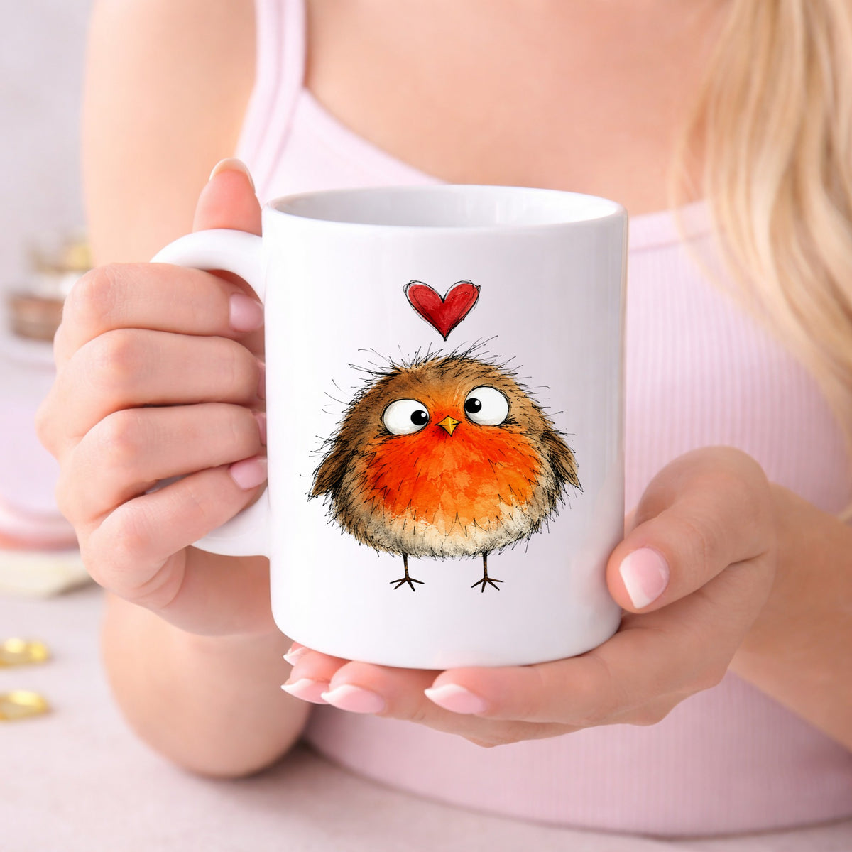 Fluffy Robin UV DTF sticker applied to a white coffee mug held in both hands