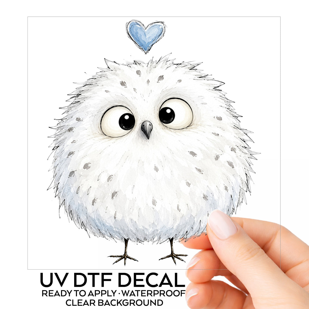 Fluffy White Owl UV DTF sticker on its backing card, held in hand