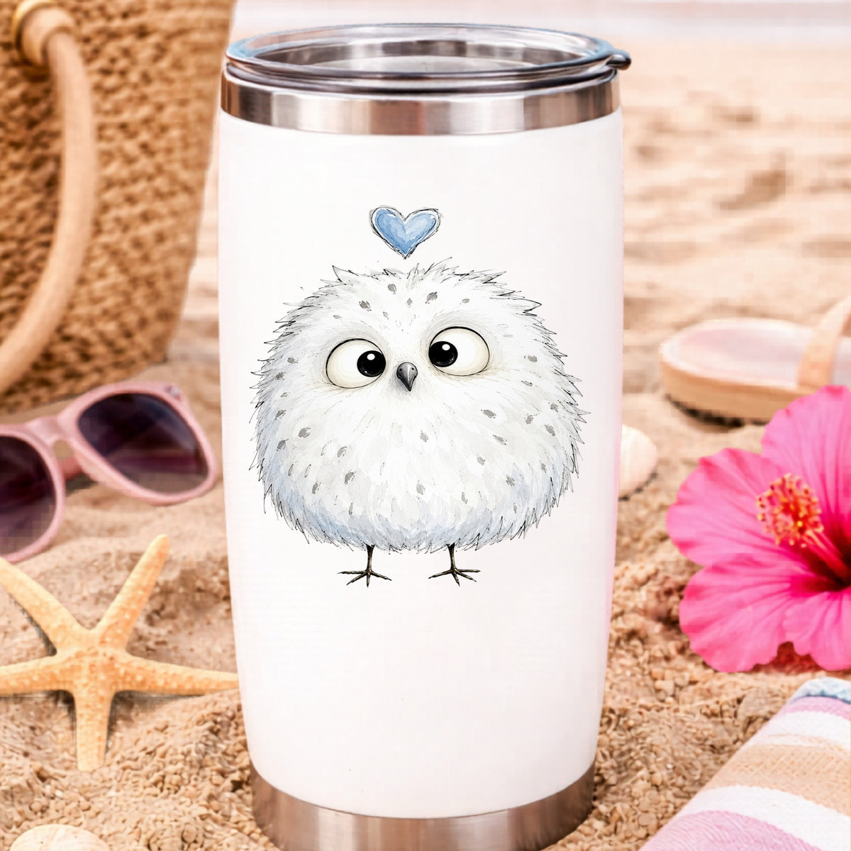 Fluffy White Owl UV DTF sticker applied to a white travel tumbler on beach sand