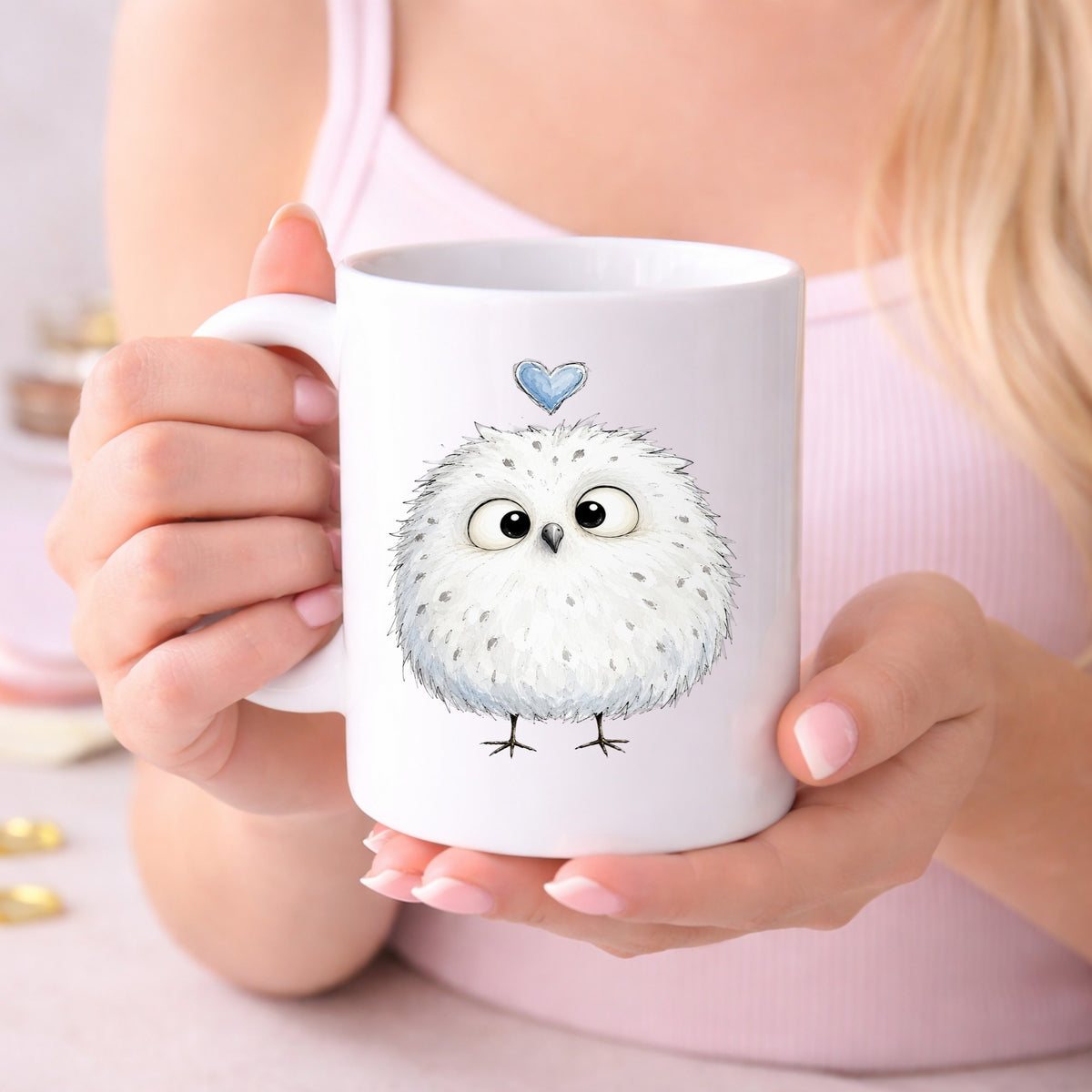 Fluffy White Owl UV DTF sticker applied to a white coffee mug held in both hands