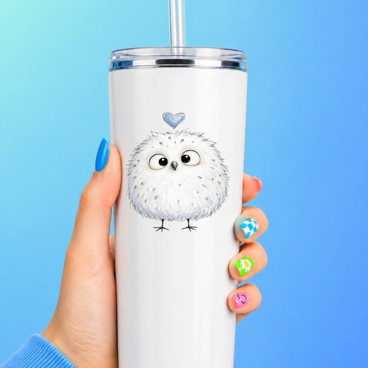 Fluffy White Owl UV DTF sticker applied to a white straw tumbler on a blue background