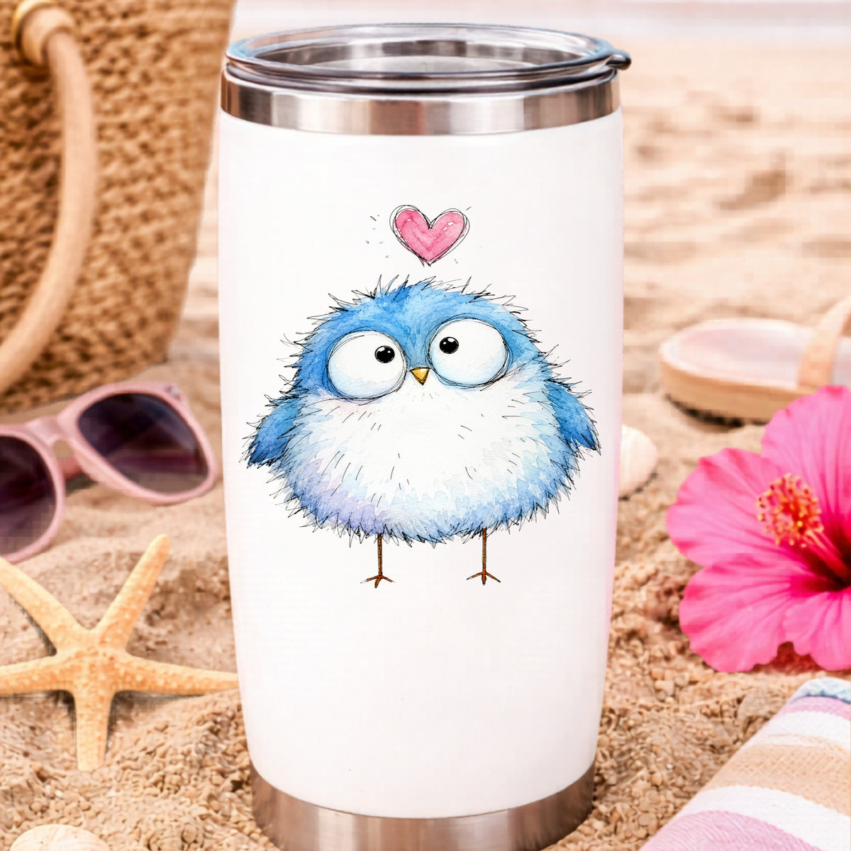 Fluffy Bluebird UV DTF sticker applied to a white travel tumbler on beach sand