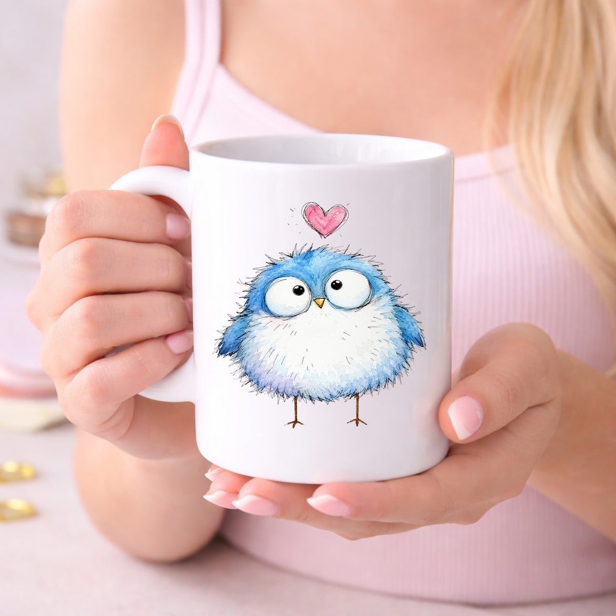 Fluffy Bluebird UV DTF sticker applied to a white coffee mug held in both hands