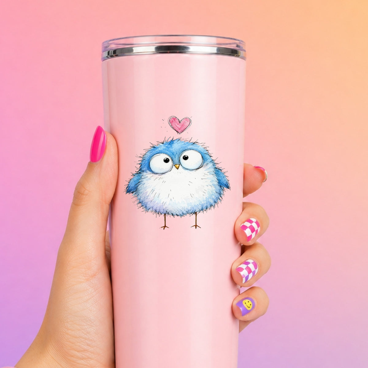 Fluffy Bluebird UV DTF sticker applied to a tall pink tumbler on a pink and orange background