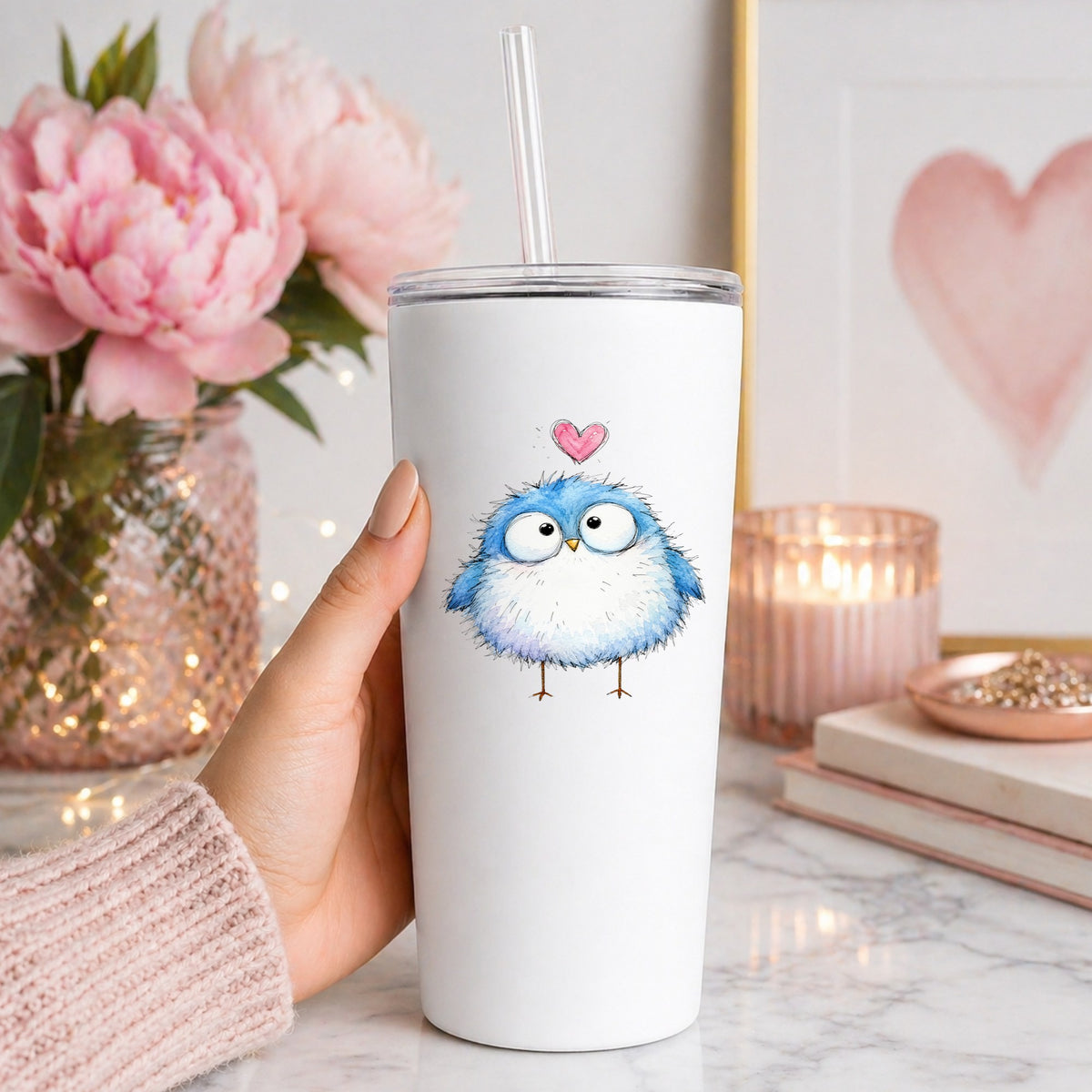 Fluffy Bluebird UV DTF sticker applied to a white straw tumbler beside pink peonies