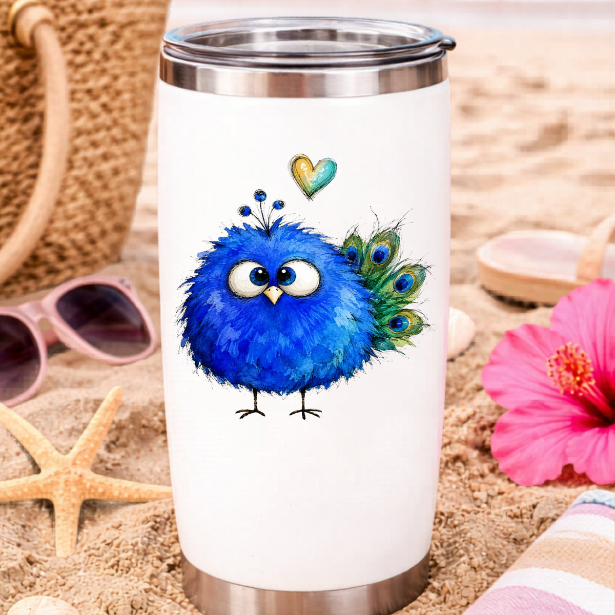 Blue Peacock Crest UV DTF sticker applied to a white travel tumbler on beach sand