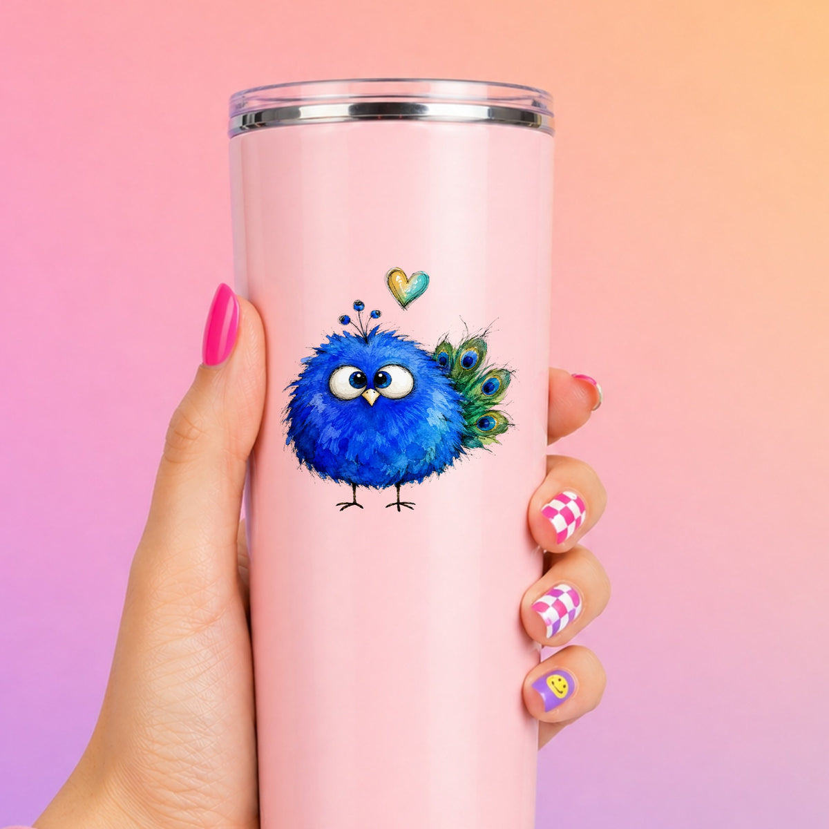 Blue Peacock Crest UV DTF sticker applied to a tall pink tumbler on a pink and orange background