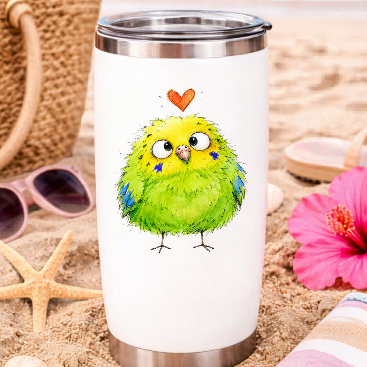 Funny Green Budgie UV DTF sticker applied to a white travel tumbler on beach sand