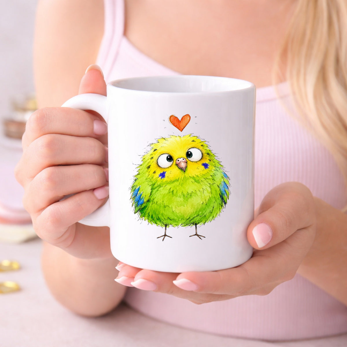 Funny Green Budgie UV DTF sticker applied to a white coffee mug held in both hands