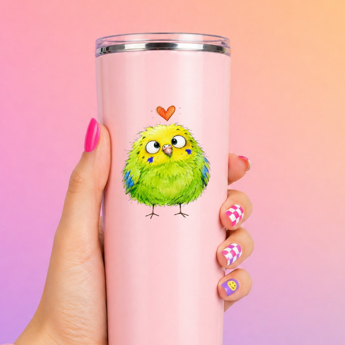 Funny Green Budgie UV DTF sticker applied to a tall pink tumbler on a pink and orange background