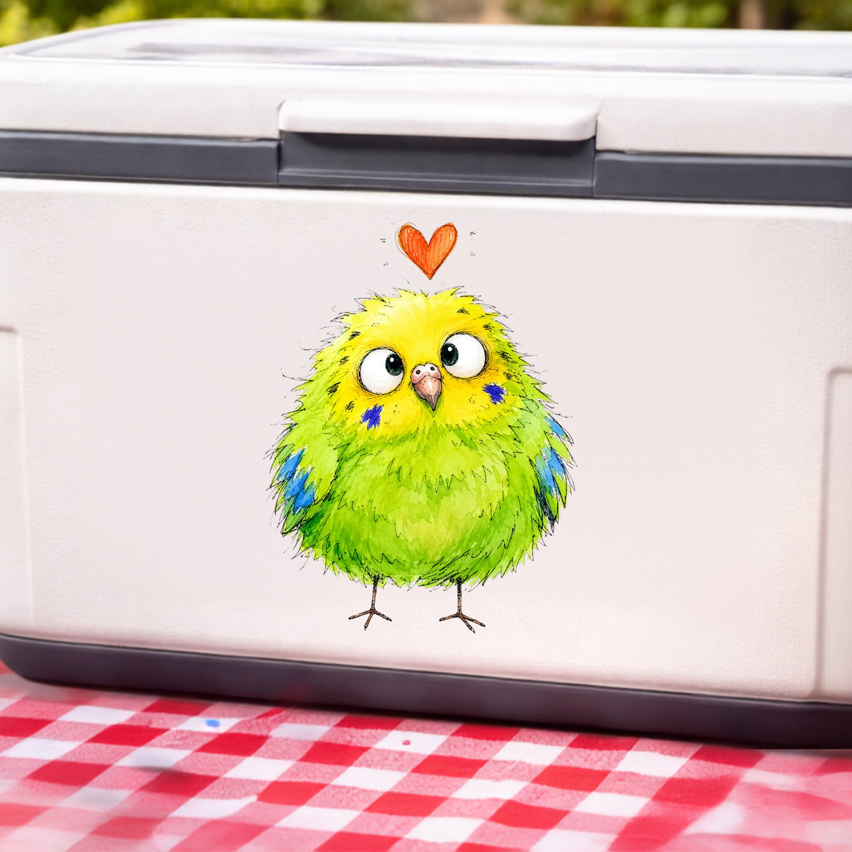 Funny Green Budgie UV DTF sticker applied to a white cooler on a red gingham cloth