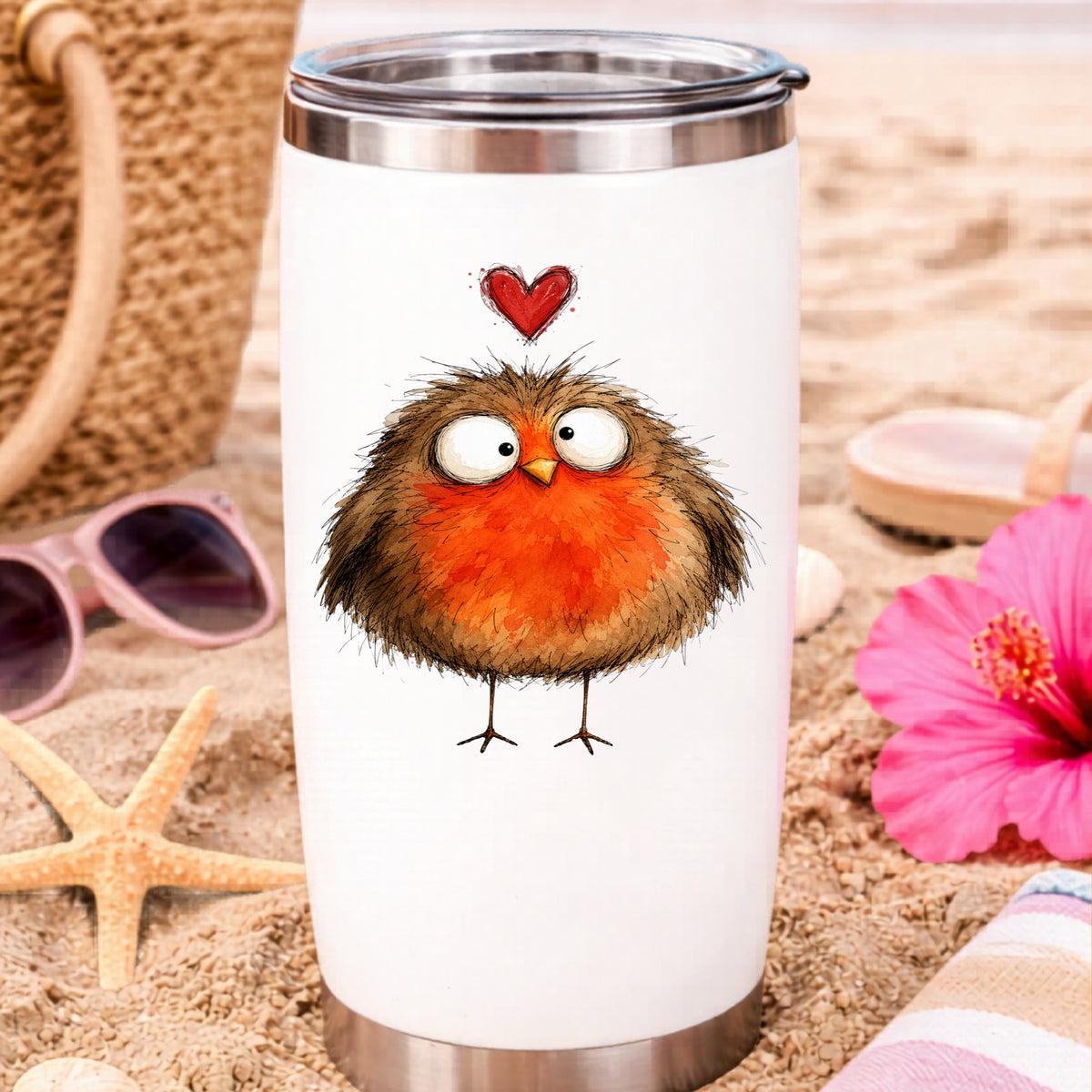 Round Robin Bird UV DTF sticker applied to a white travel tumbler on beach sand