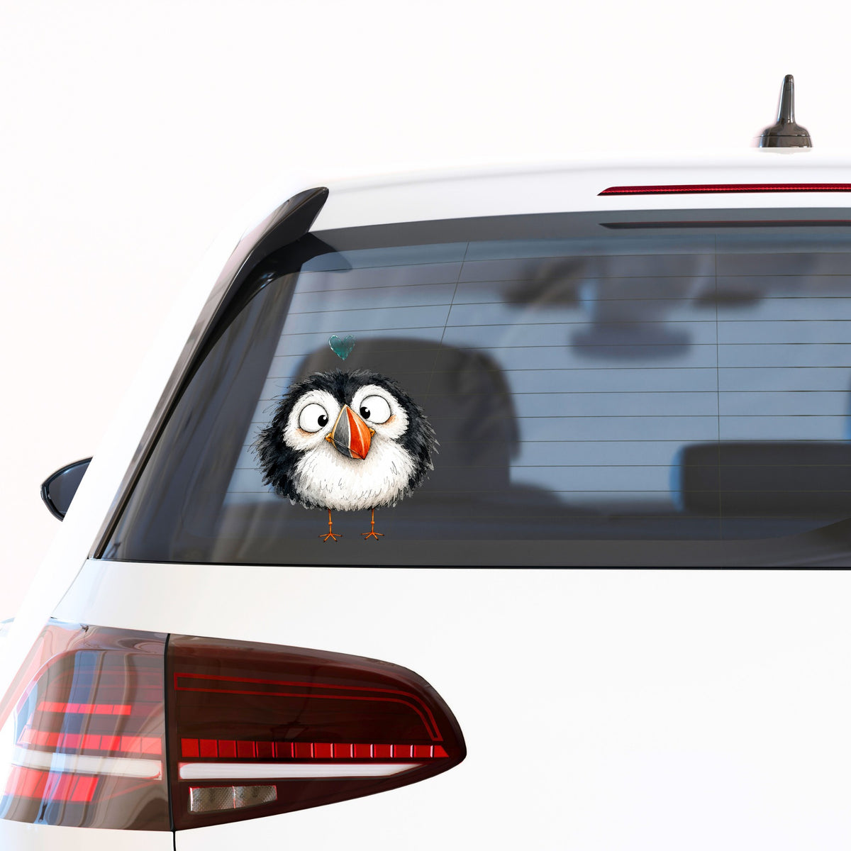 Cartoon Puffin UV DTF sticker applied to the rear window of a white car