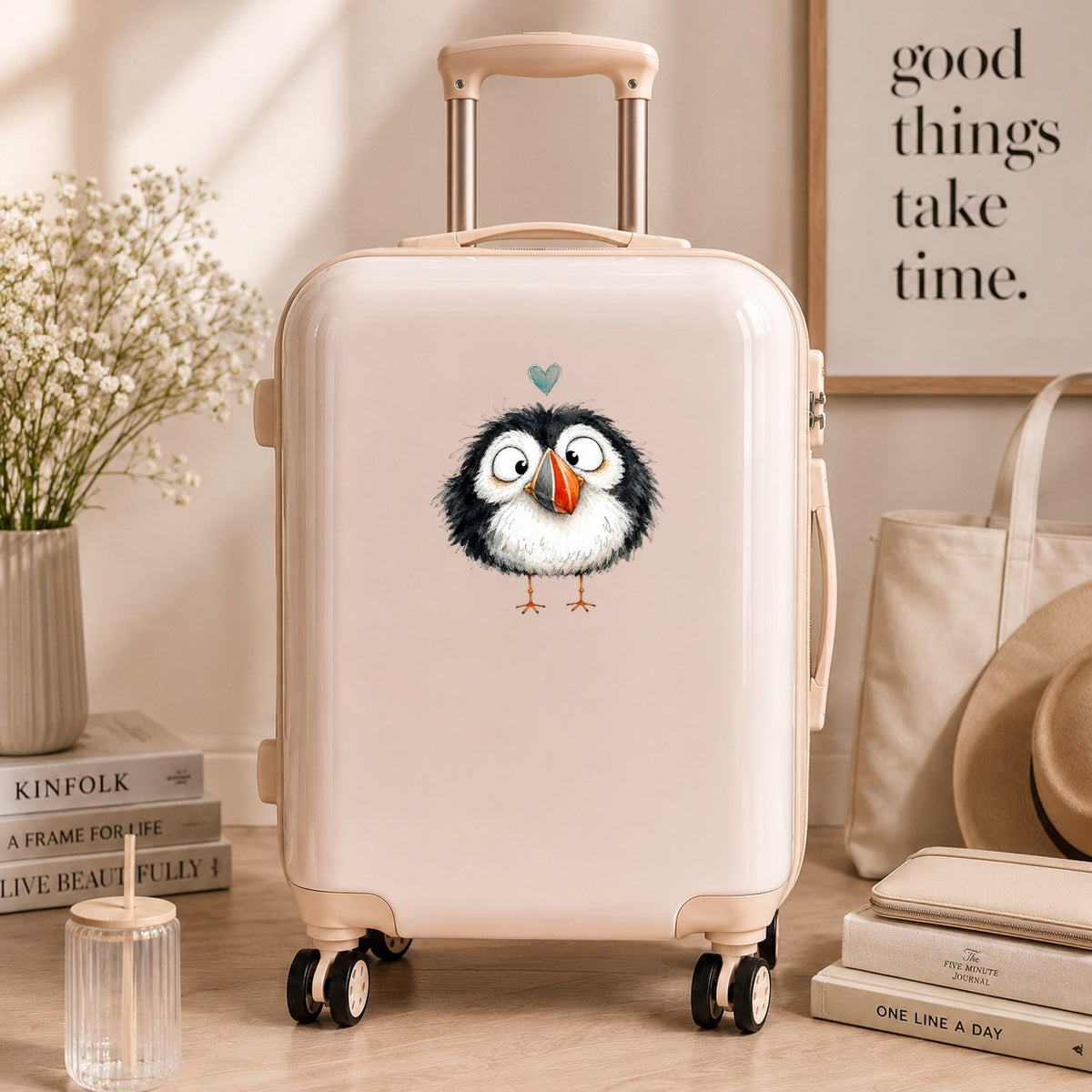 Cartoon Puffin UV DTF sticker applied to a cream carry-on suitcase