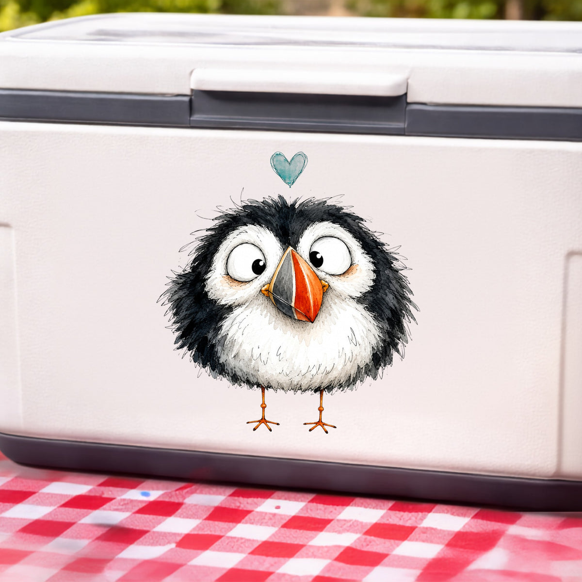 Cartoon Puffin UV DTF sticker applied to a white cooler on a red gingham cloth