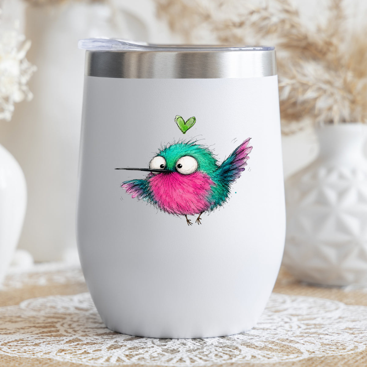 Flying Cartoon Hummingbird UV DTF sticker applied to a white stemless tumbler with a lid