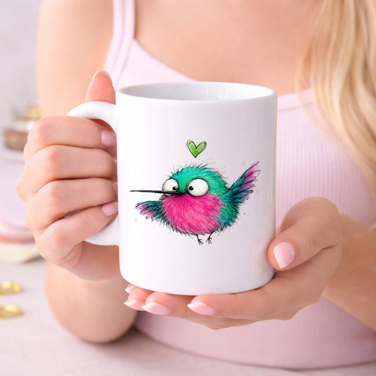 Flying Cartoon Hummingbird UV DTF sticker applied to a white coffee mug held in both hands