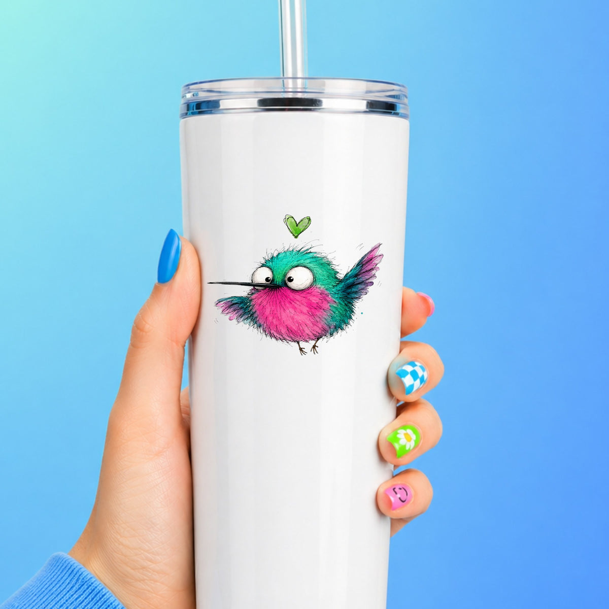 Flying Cartoon Hummingbird UV DTF sticker applied to a white straw tumbler on a blue background