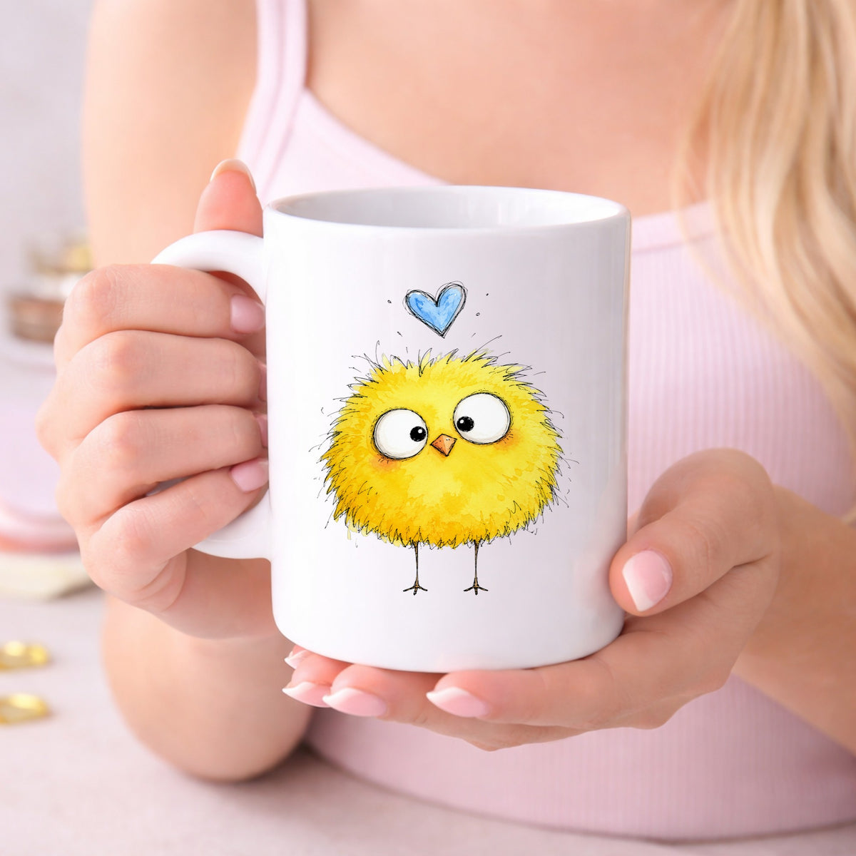 Fluffy Yellow Chick UV DTF sticker applied to a white coffee mug held in both hands