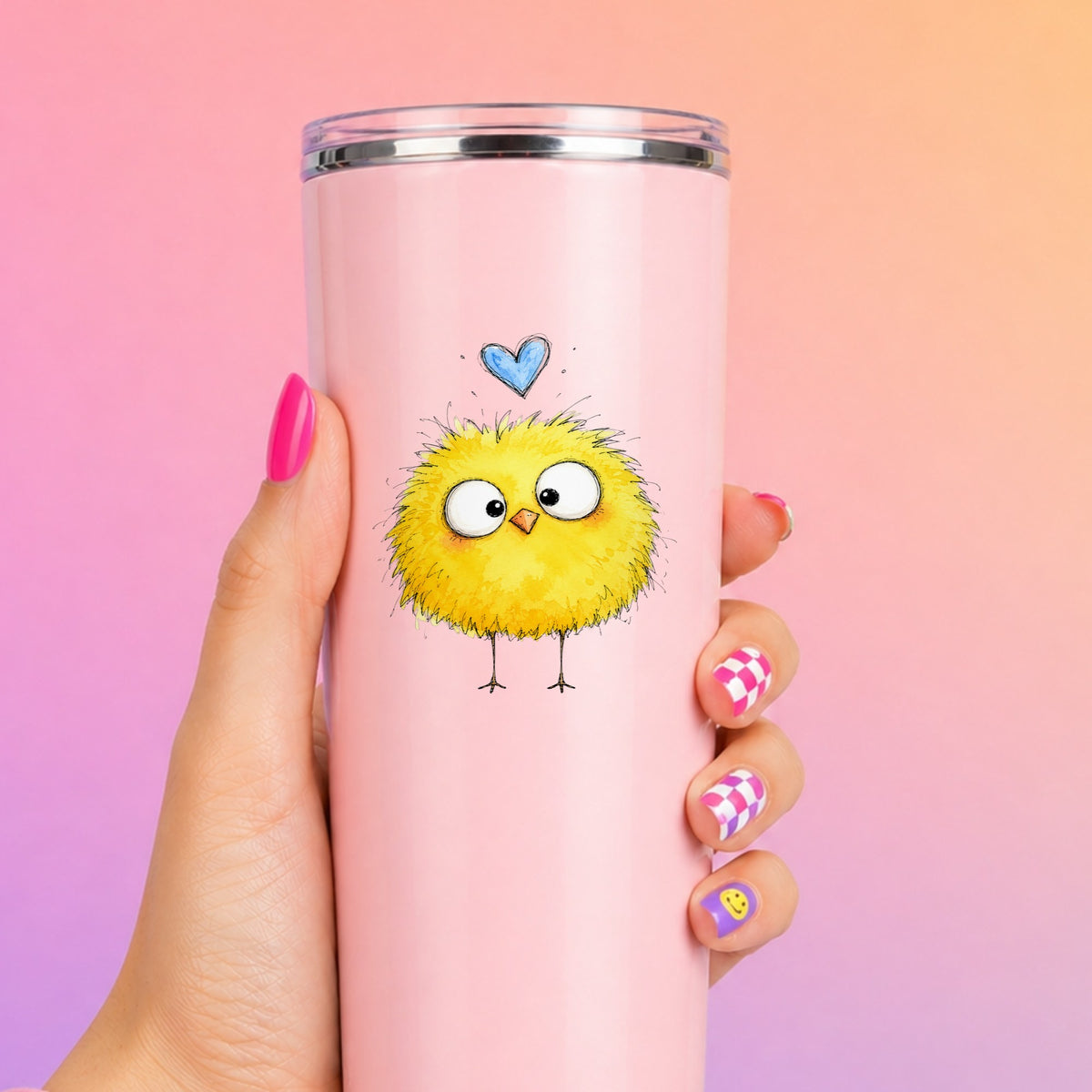 Fluffy Yellow Chick UV DTF sticker applied to a tall pink tumbler on a pink and orange background