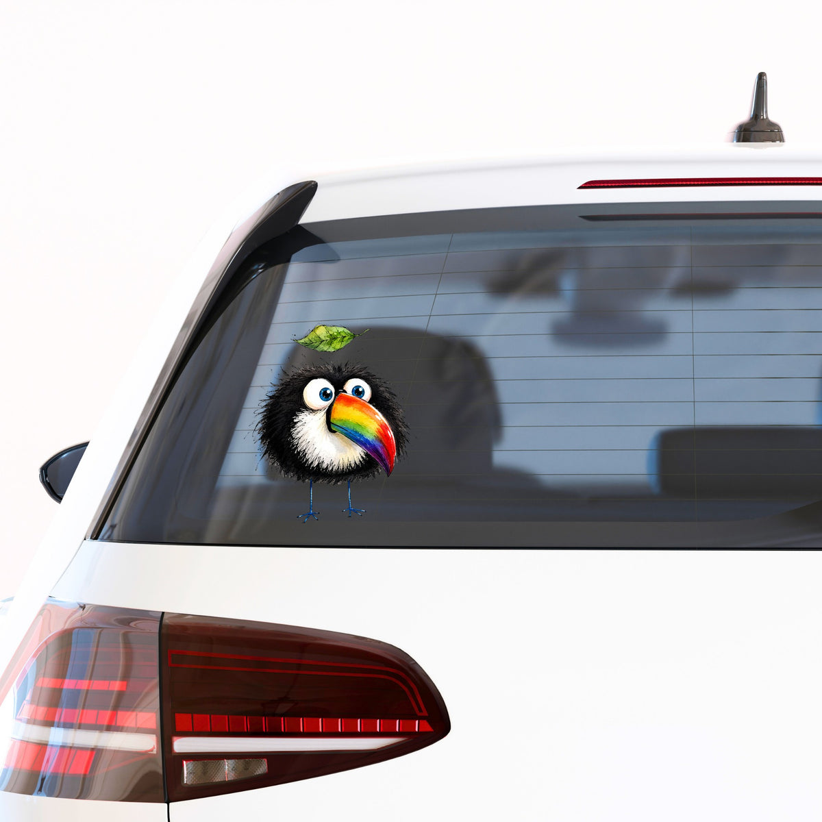 Toucan With Leaf UV DTF sticker applied to the rear window of a white car