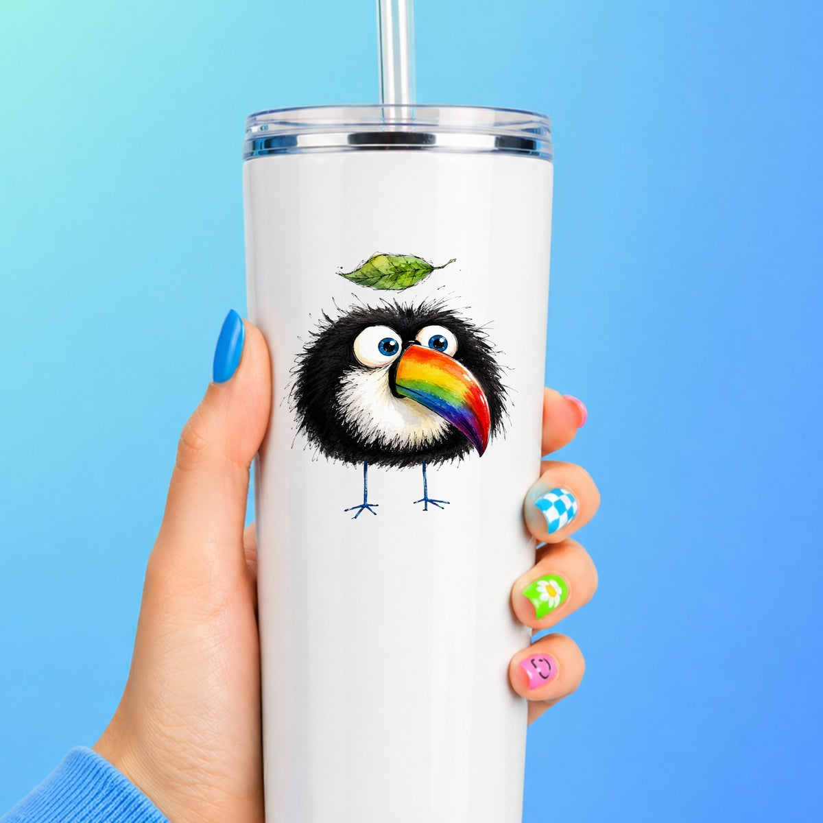 Toucan With Leaf UV DTF sticker applied to a white straw tumbler on a blue background