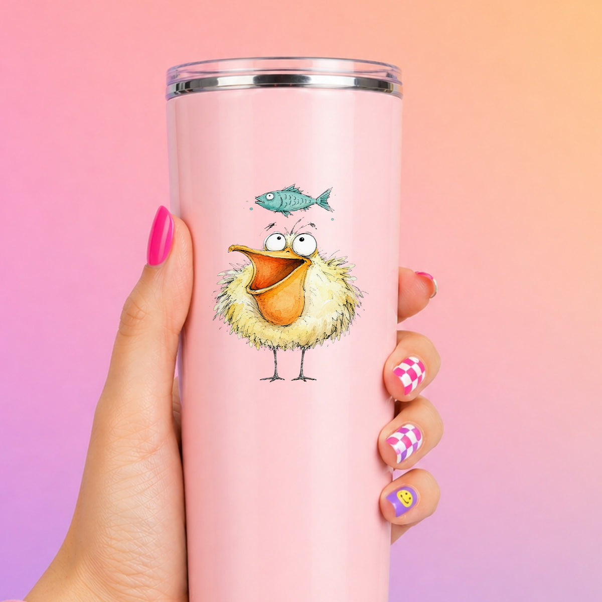 Funny Pelican With Fish UV DTF sticker applied to a tall pink tumbler on a pink and orange background