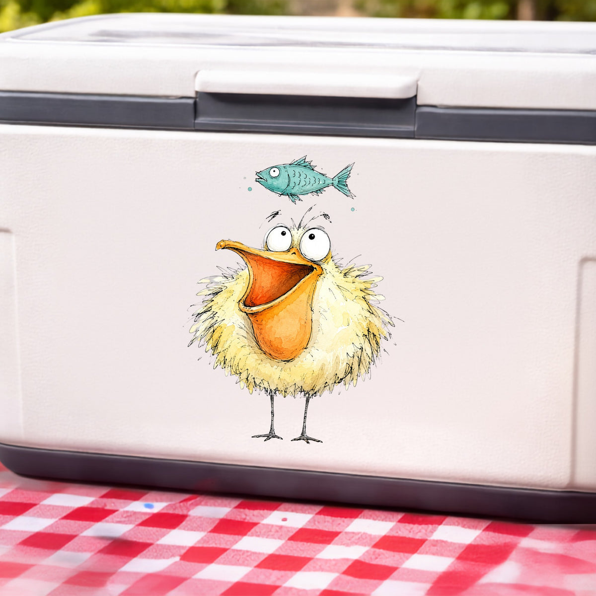 Funny Pelican With Fish UV DTF sticker applied to a white cooler on a red gingham cloth