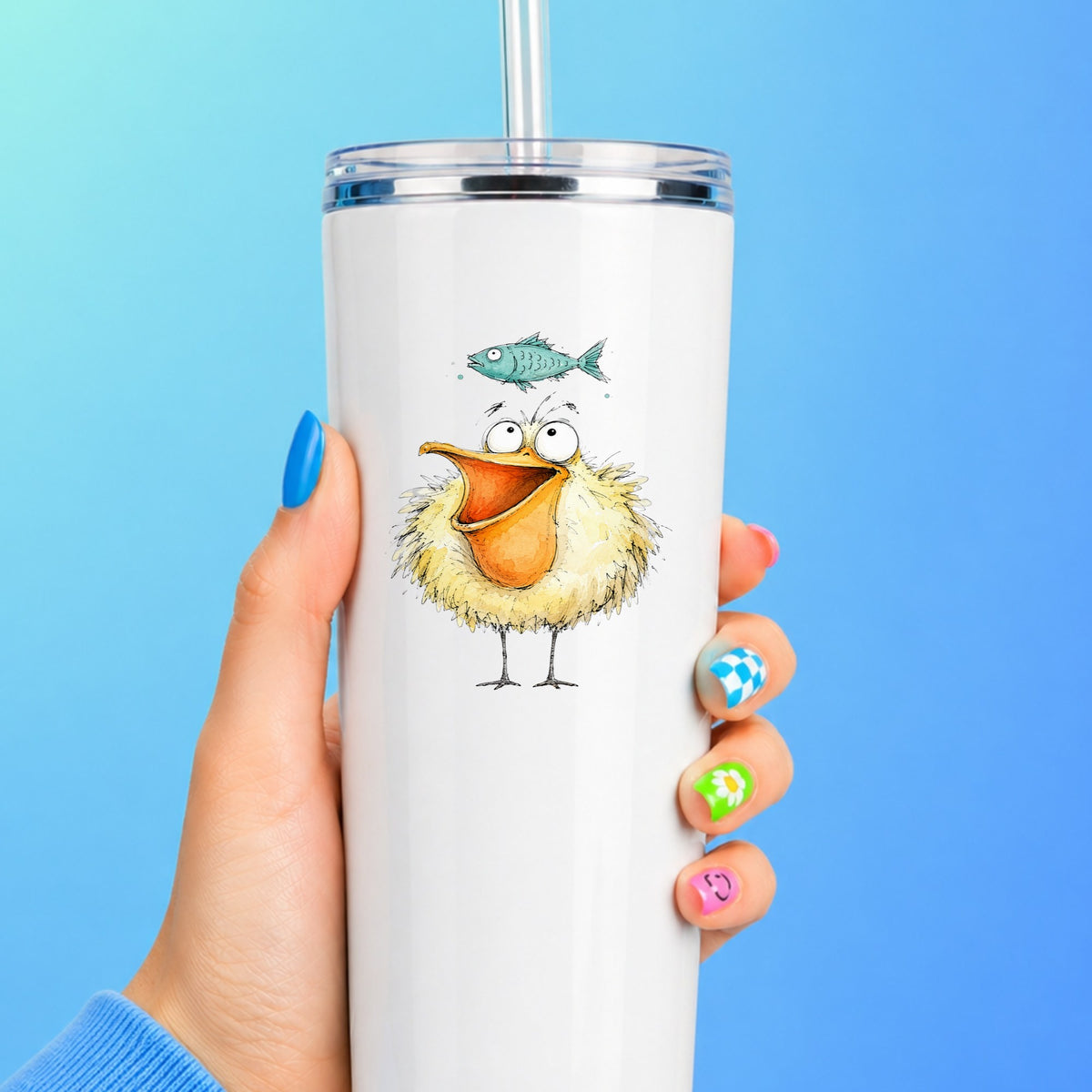Funny Pelican With Fish UV DTF sticker applied to a white straw tumbler on a blue background
