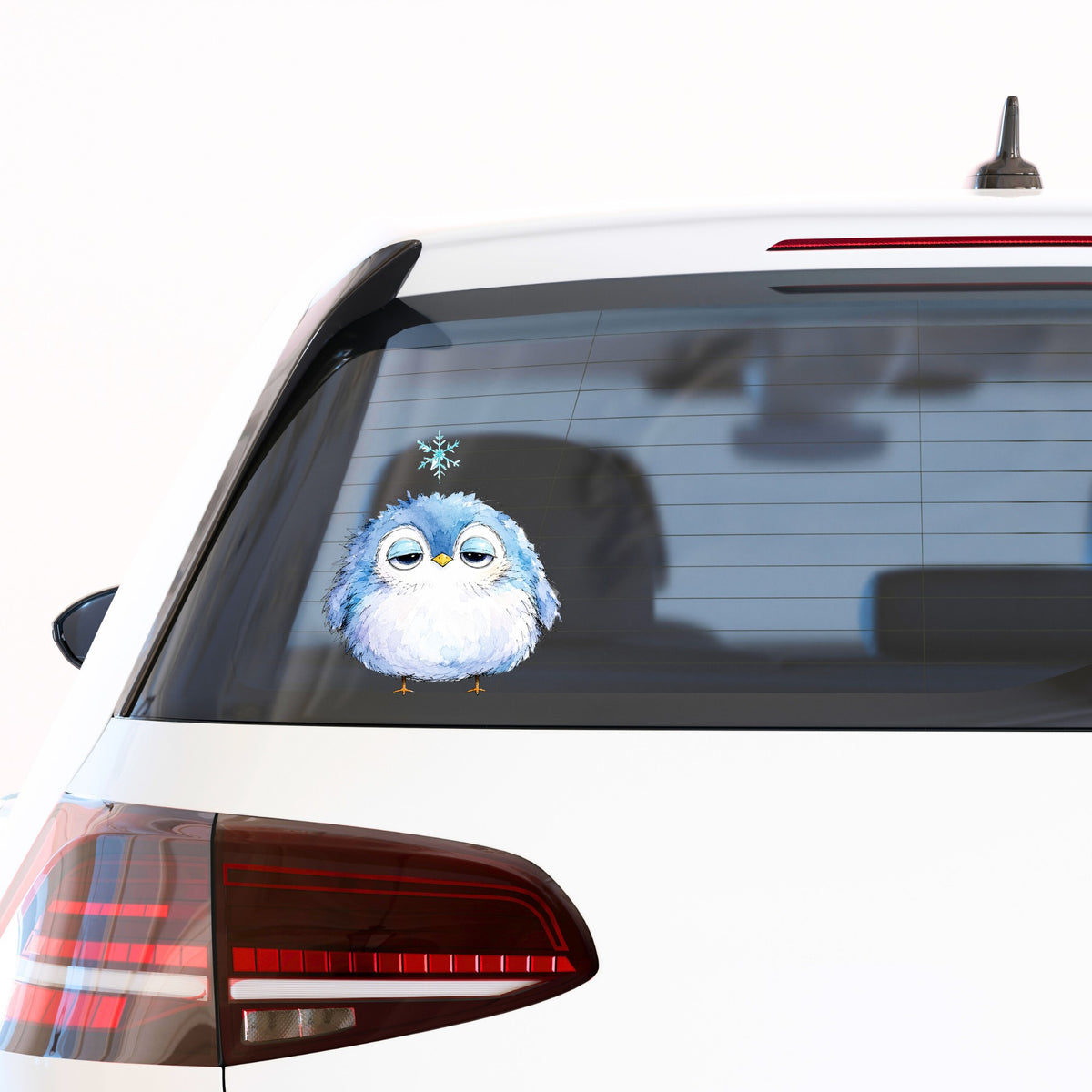 Sleepy Blue Bird Snowflake UV DTF sticker applied to the rear window of a white car