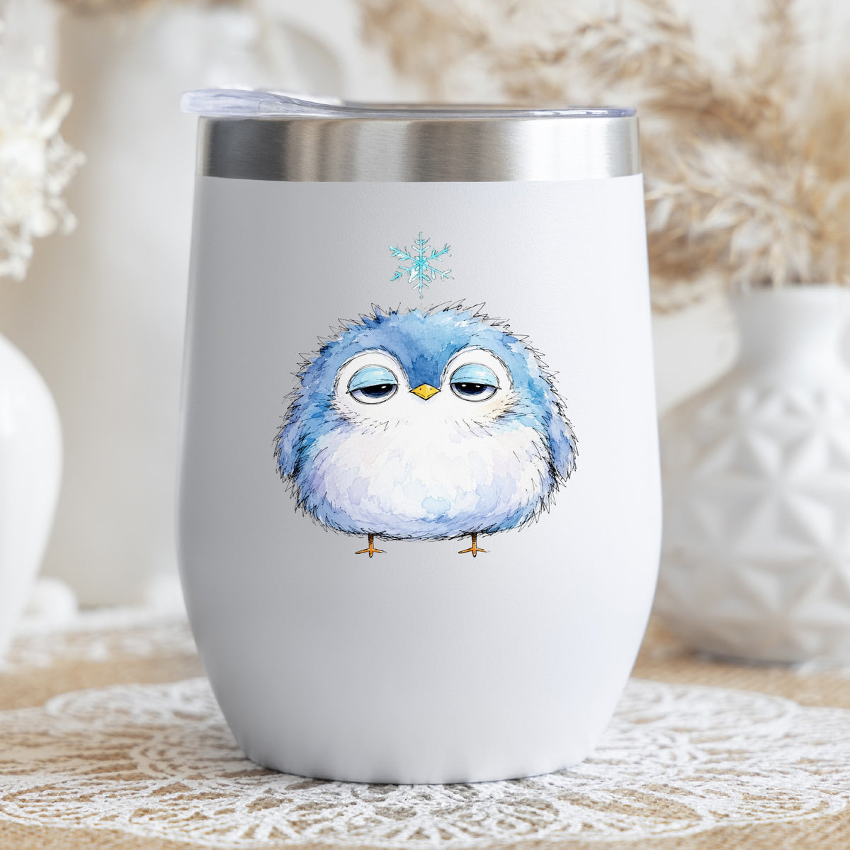 Sleepy Blue Bird Snowflake UV DTF sticker applied to a white stemless tumbler with a lid