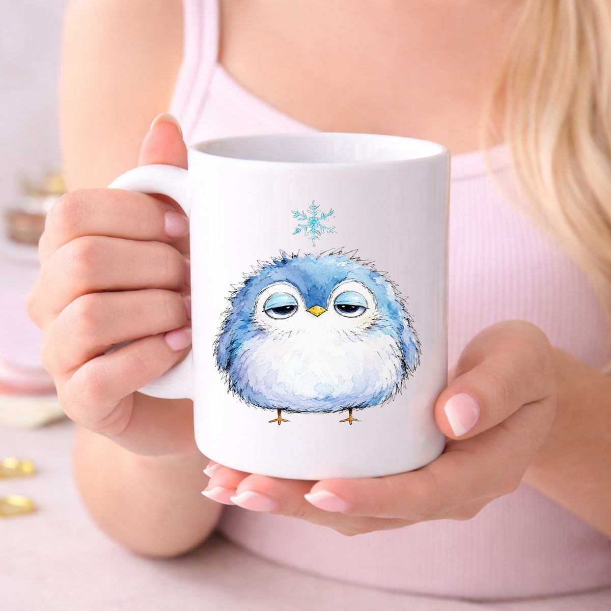 Sleepy Blue Bird Snowflake UV DTF sticker applied to a white coffee mug held in both hands